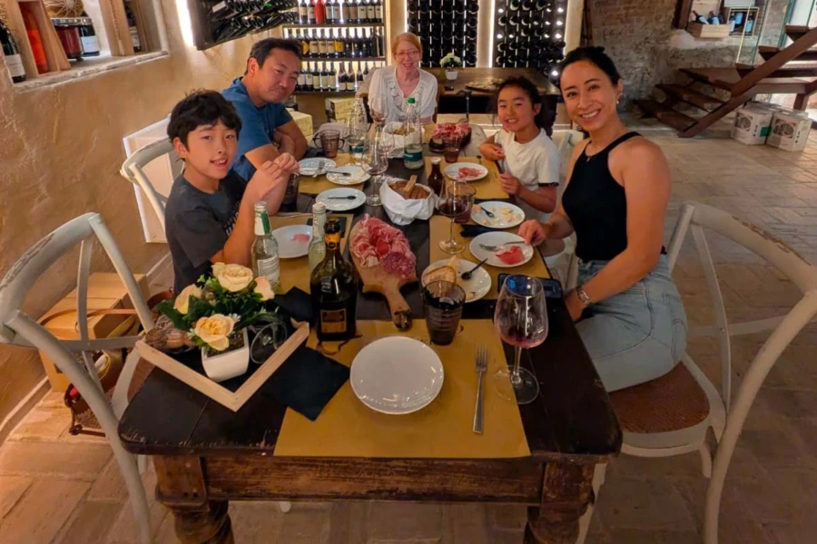 small group enjoying tastings with the guide during our parma food tour city walk