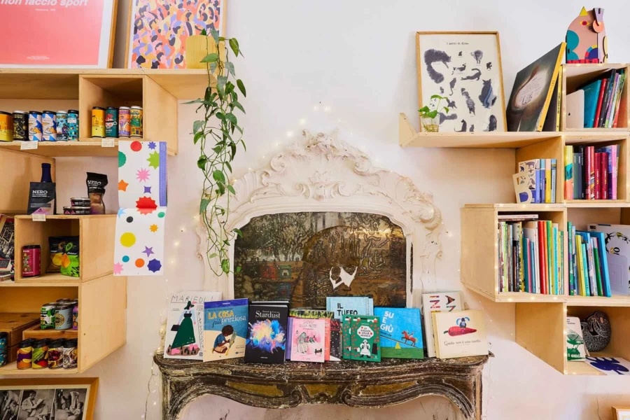 A curated display of children's books and creative decor inside Zoo, a kid-friendly cafe and cultural hub in Bologna.