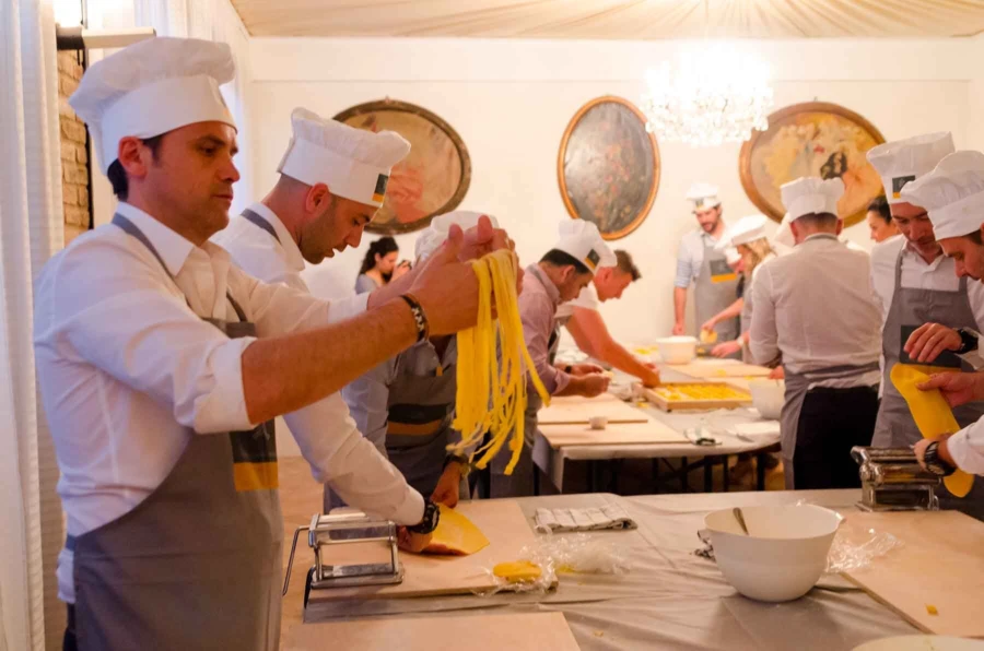 A group of people for a pasta making team building in Bologna
