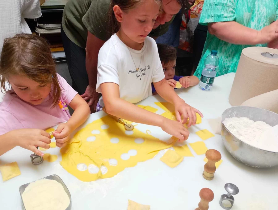 Kids making pasta during a cooking class in Bologna