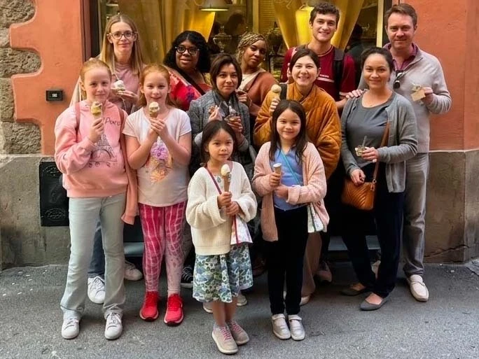 A large family with kids enjoying gelato in Bologna